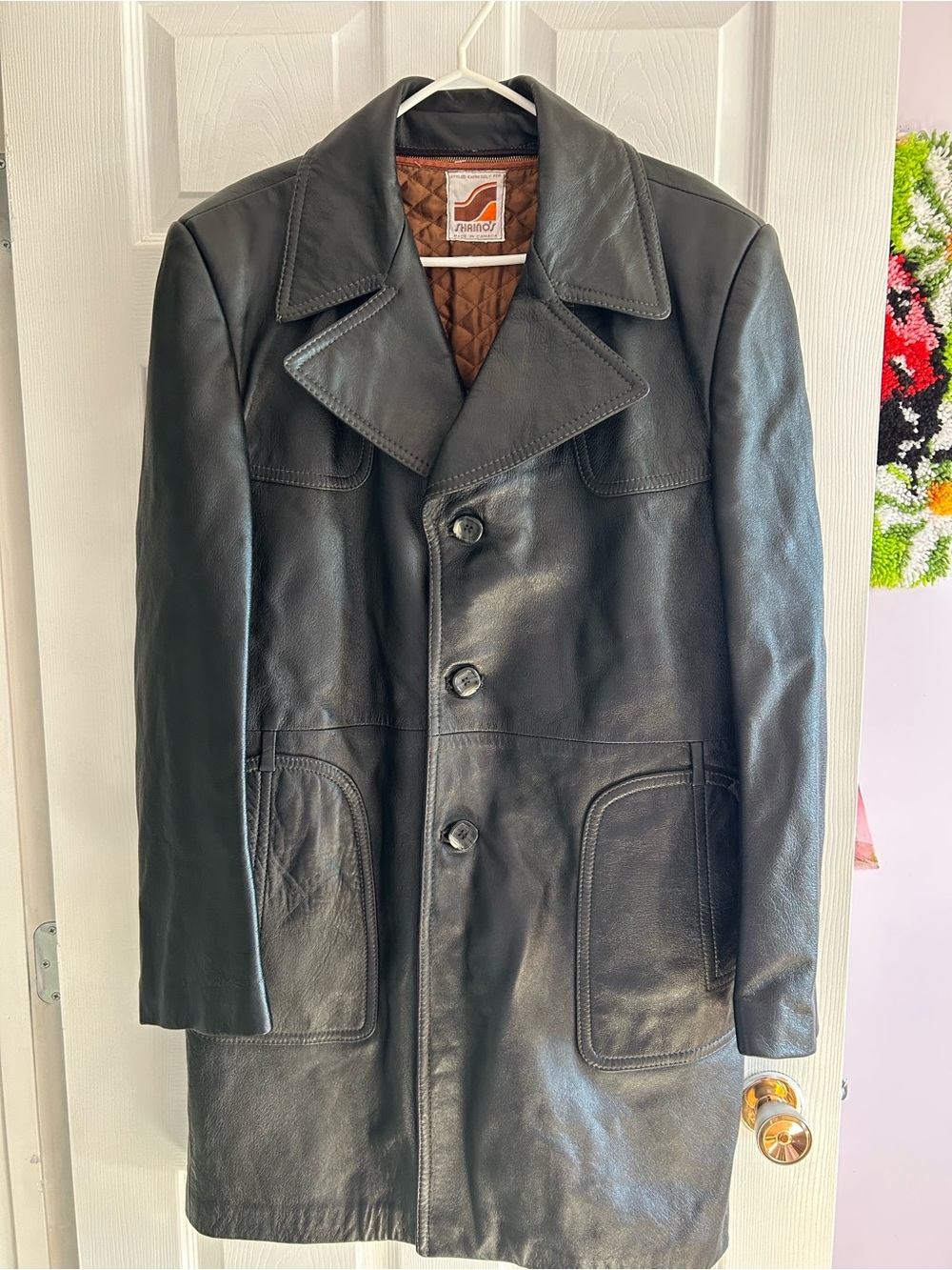 A vintage black leather jacket with quilted lining by Shaino's.